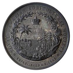 Round silver medal with busy seaport scene, text around.