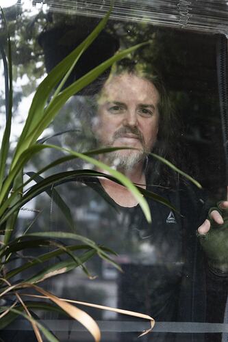 Public Housing Resident Stephen Duff Peers Out from his Window during the COVID-19 Pandemic, Richmond, Victoria, 7 May 2020