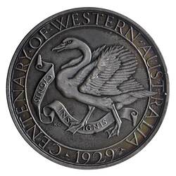 Silver medal with swan advancing left with wings spread. Scroll below and text around.