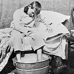Negative - Boy Seated on Bed With Feet in a Washtub, Merrigum, Victoria, 1910