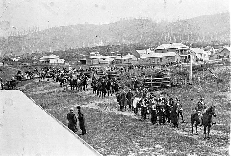 People and horses in a procession.