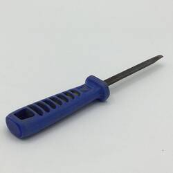 Three quarter view of metal chisel with blue plastic handle.