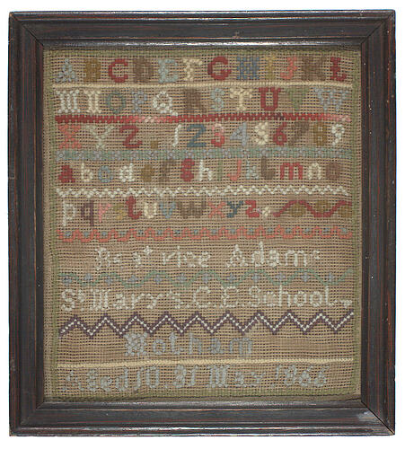 Framed embroidery sample. Rows of coloured stitching including alphabet and names. on off white fabric.