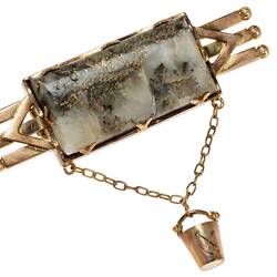 Tripple bar brooch with central quartz and gold specimen with small gold bucket attached via chain.