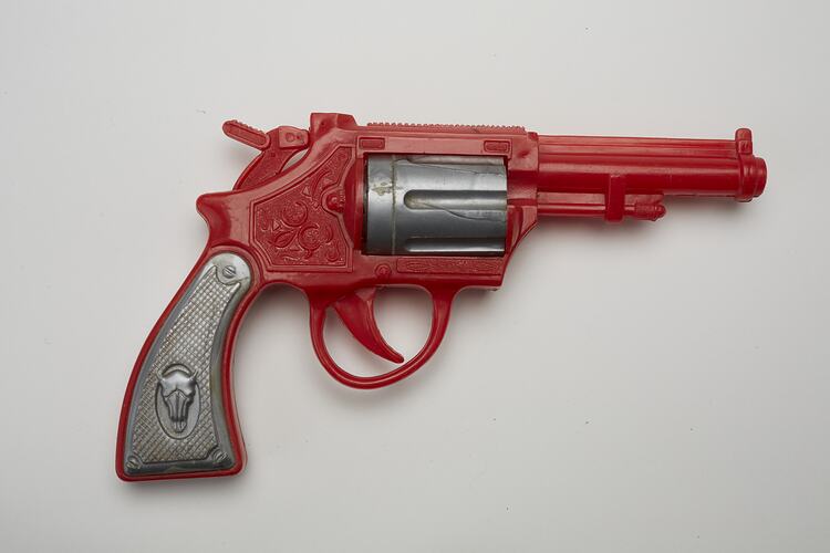 Red and grey plastic toy revolver, right profile.