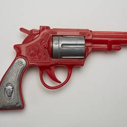 Red and grey plastic toy revolver, right profile.