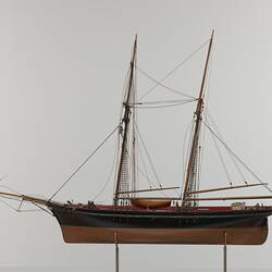 Black and brown sailing ship model. Two masts. Left profile.