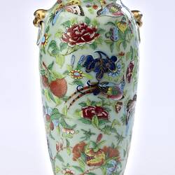 Porcelain vase with all-over pattern of birds, flowers, butterflies and two rats climbing amongst branches.