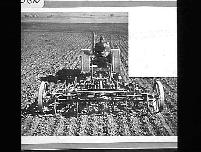 Photograph - Man on Tractor cultivating Field