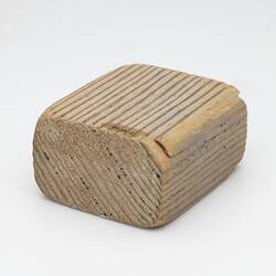 Block of pale-coloured wood.