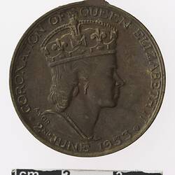 Round medal with profile of a crowned woman.