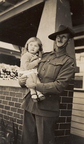 Digital Photograph - Serviceman Holding his Daughter, Front Verandah, Brunswick West, 1940