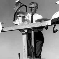 Photograph - CSIRAC Computer, John Spencer Adjusting the Shade Ring on Solar Radiation Measuring Equipment at CSIRO Highett, 1968