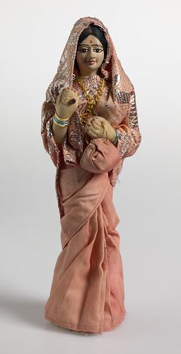 Indian female figure wrapped in pink sari material.