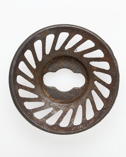 Pasta maker - metal circle with pattern of rounded-triangular holes.