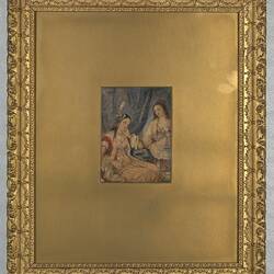 Painting of two women gossiping in a gold mount and frame.