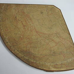 Quarter circle shaped wooden board with map.