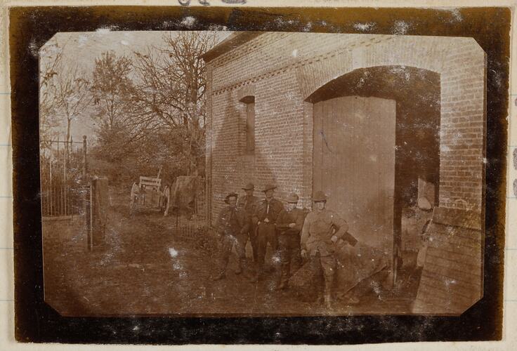 Soldiers standing at the entrance to stable.