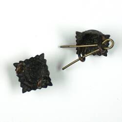 Two metal pins, back view.
