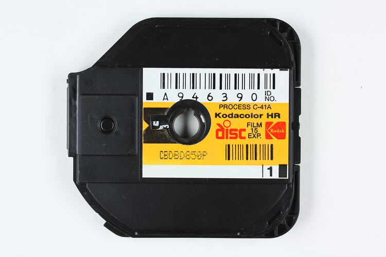 Black plastic film disc with printed label.