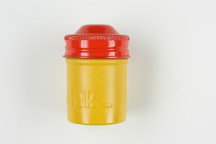 Red and yellow embossed, screwtop metal film canister.