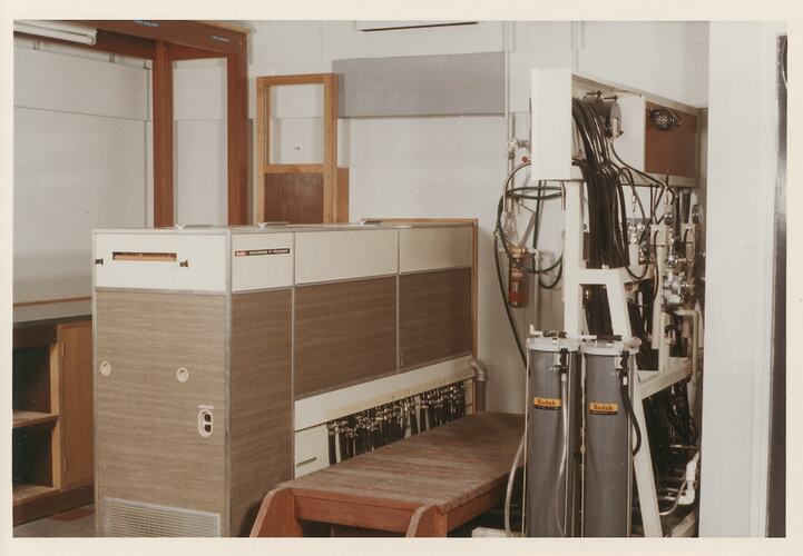 Large machine with tubing, hoses and wood panelling.