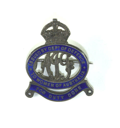 Badge front with crown and scroll motifs.