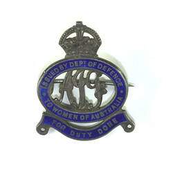 Badge front with crown and scroll motifs.