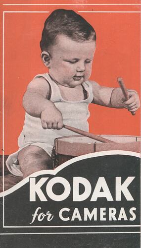 Cover page with photograph of baby playing drums.