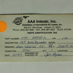 Red cylindrical container with two electrical cords at one end.