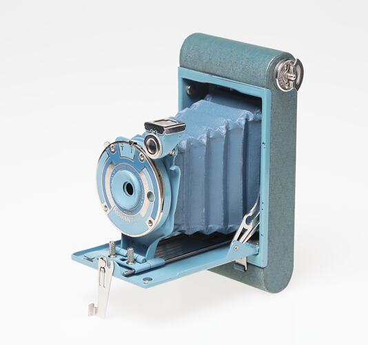 Pale blue metal camera. Front flips open for concertina style camera lens to pop out of.