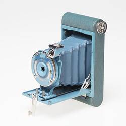 Pale blue metal camera. Front flips open for concertina style camera lens to pop out of.