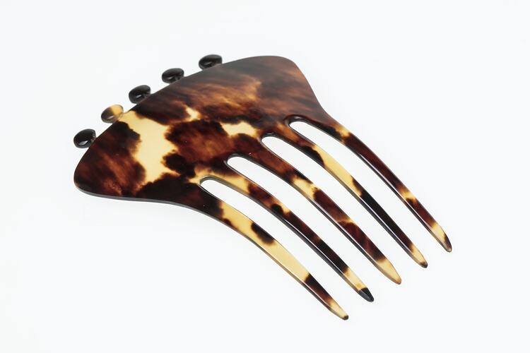 Tortoiseshell hair comb, five tines and knobs on base.