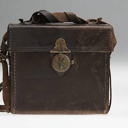 Black movie camera with brown leather carry bag.