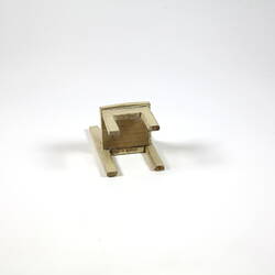 Underside of cream toy chair.