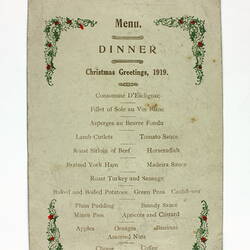 Front of printed menu with holly decoration.