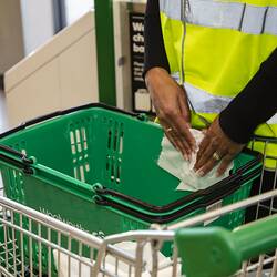 Digital Photograph - Close-up View of Staff Member Wiping Down and Sanitising Shopping Basket, Woolworths, Blackburn South, 18 May 2020
