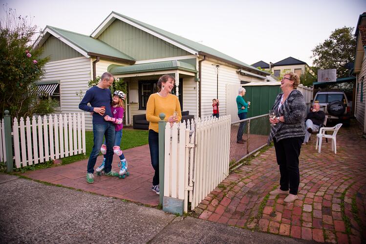 Neighbours interacting across their fence during COVID-19 lockdowns, Northcote, Victoria