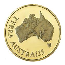 Round medal with relief map of Australia, text around.
