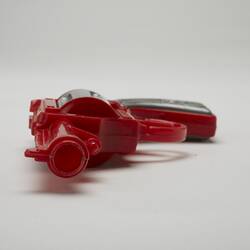 Red and grey plastic toy revolver, barrel view.