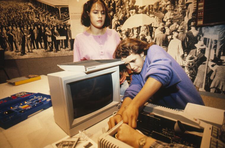 Students setting up computer and printer.