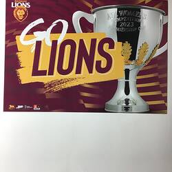 Maroon poster with printed white and maroon text on yellow and silver trophy cup.