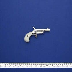 Silver pistol with white grip