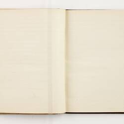Open book with off white ruled pages.