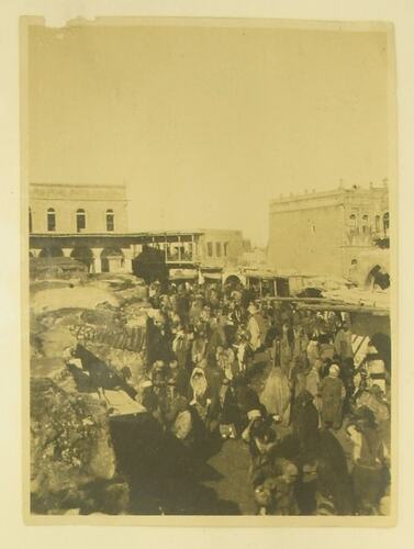 Buildings and crowds in bazaar, photgraphed from above crowd.