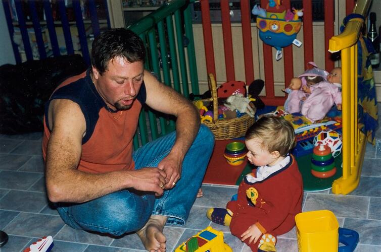 Digital Photograph - Father with Baby Daughter and Toys, Delahey, 2003