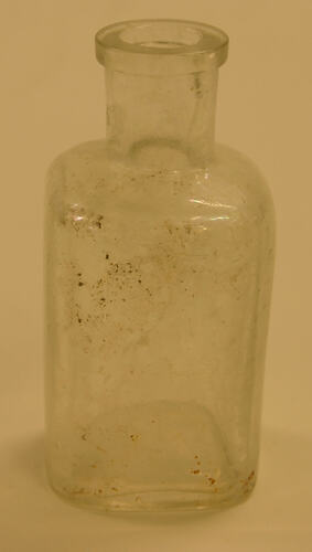 Flange lipped, square bodied glass bottle.