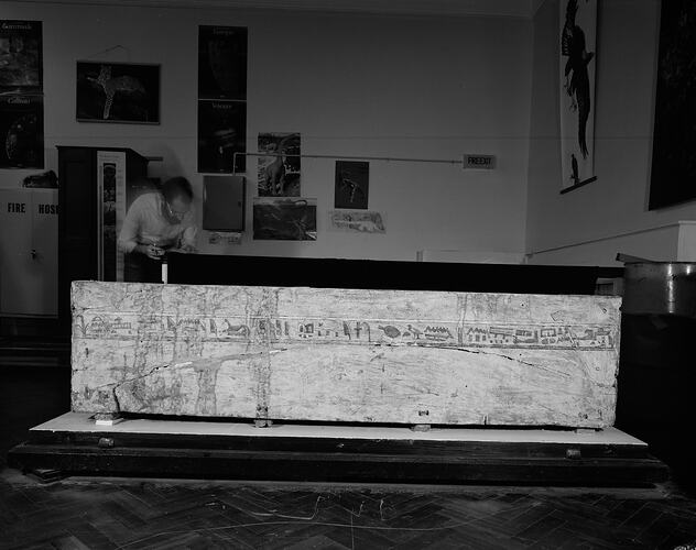 Man looking at Egyptian hieroglyphs on Tjeby's sarcophagus