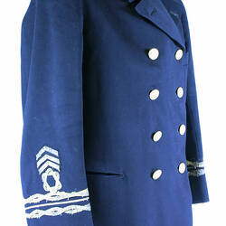 Navy tunic, double breasted with metal buttons, Sleeves have three chevrons, circle and three bands.