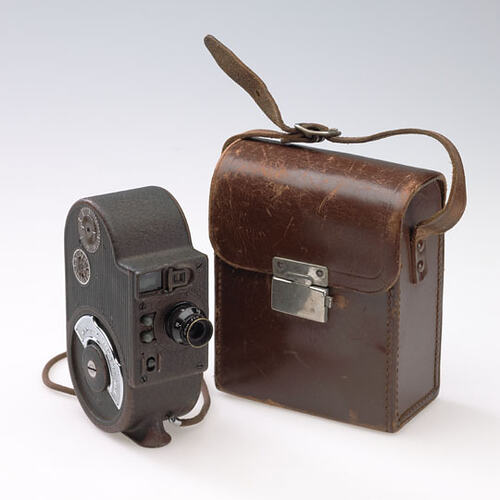 Old movie camera with leather case.